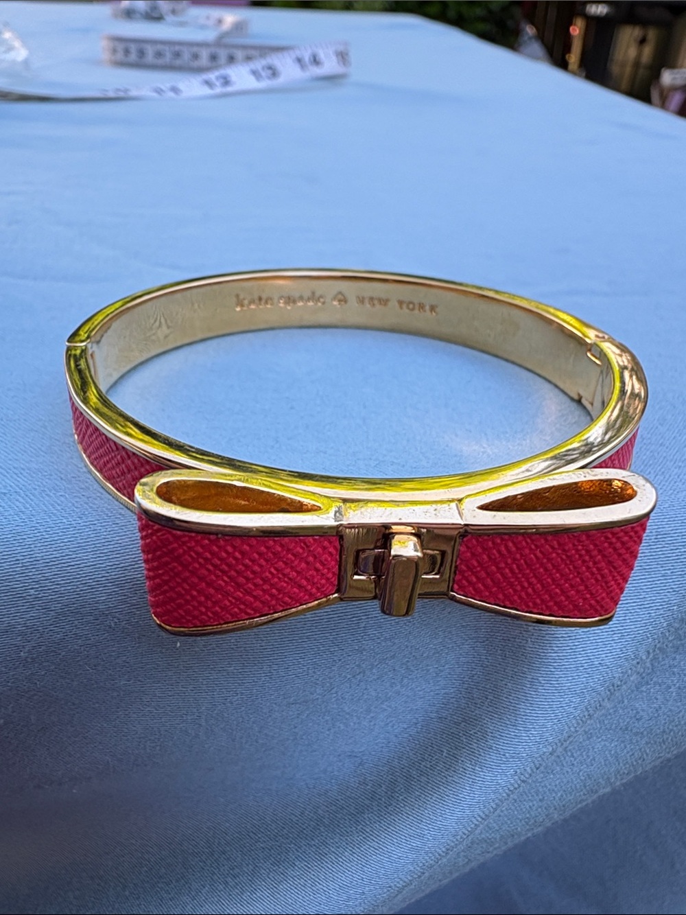 kate spade gold-tone bangle with pink enamel bow